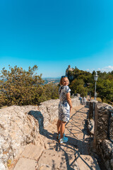 Wall Mural - Young beautiful woman smiles against the backdrop of the Guaita Fortress, San Marino, Italy