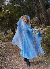 A woman plays with her foulard in springtime