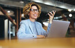 © Jacob Lund - Professional business woman speaking on a mobile phone in an office
