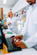 © bernardbodo - Diverse pharmacists working at counter.