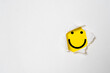 © Dilok - Smile face inside yellow background and white punch paper with copy space for positive mindset and client excellent evaluation concept , Customer experience and quality feedback concept.
