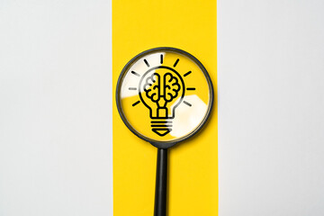 Poster - drawing of glowing light bulb with brain inside of magnifier glass for creative thinking idea and pr