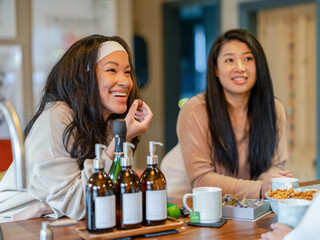 Poster - Female friends talking and eating in kitchen