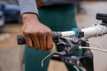 Close-up of woman's hand on bicycle handlebar
