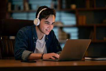 Aufkleber - Young smiling man working on laptop late at night