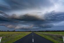 Low Angle View Of A Country Road Running Under A Dark Dramatic Stormfront