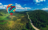 Fototapeta  - Hot air balloons floating up to the sky . Aerial drone shot