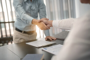 Wall Mural - Business man Successful Ideas team shaking hands in Meeting room.