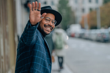 man on the street waving