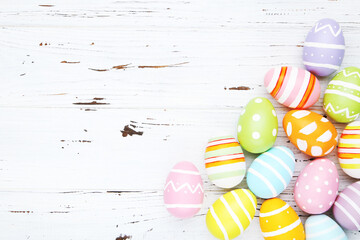 Wall Mural - Colorful eggs on white wooden background