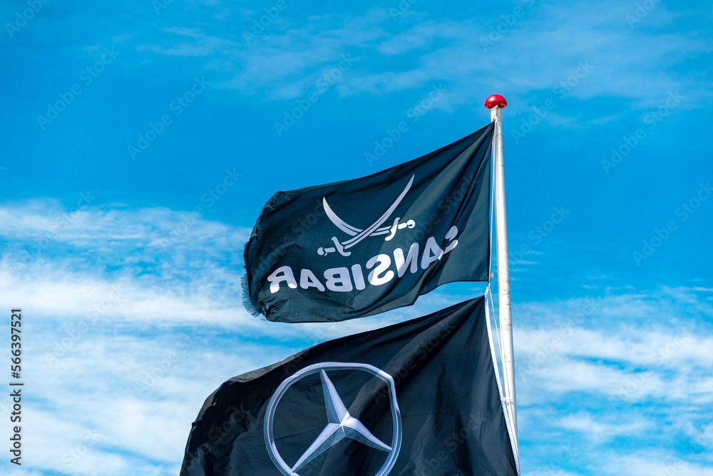 Mercedes Benz flag and Zanzibar flag in black on Sylt on the beach in ...