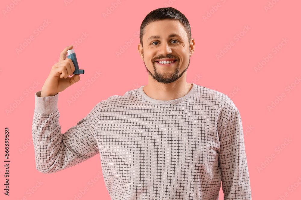 Man with inhaler on pink background
