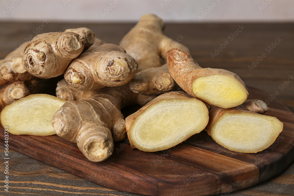 Cutting board with fresh ginger on table