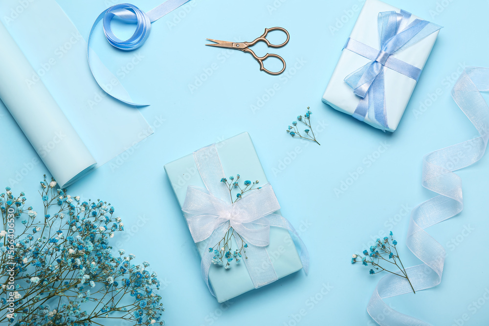 Composition with gift boxes, ribbon, scissors and gypsophila flowers on color background. Women's Day celebration