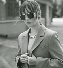 Wall Mural - Portrait of beautiful stylish young woman in sunglasses in outdoor. Close up photo.