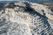 © Parilov - Top view Industry marble quarry and cut white blocks, working yellow tractor, drone aerial