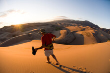 Man Hiking In Sand Dunes.