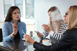 © New Africa - Women smoking cigarette at table in outdoor cafe