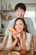 © bongkarn - Portrait of Lovely young Asian couple, boyfriend and girlfriend, in the kitchen together