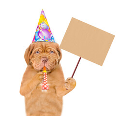 Poster - Mastiff puppy wearing party cap blows into party horn and shows empty placard. isolated on white background