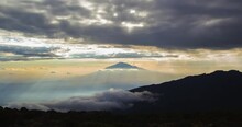 Amazing Sunset With Rays Of Light Peaking Through The Clouds Over Mount Meru, Seen From Shira Camp On Mount Kilimanjaro In Tanzania.