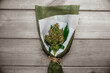 A bouquet of marijuana flowers on a wooden plank.
