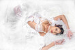 © Mongkolchon - beautiful asian bride in sexy lingerie laying on white lace fabric