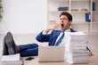 © Elnur - Young male employee and too much work in the office