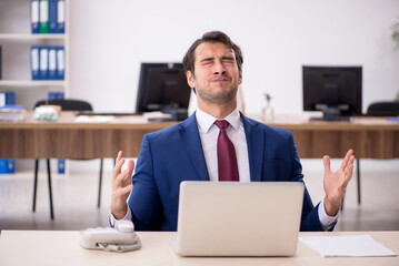 Young male employee working in the office