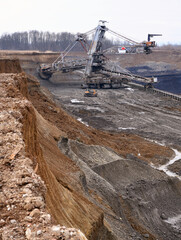 Wall Mural - Bucket-wheel excavator during excavation at the surface mine. Huge excavator on open pit mine.