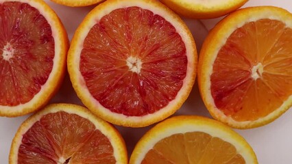 Wall Mural - Footage in 4K of spinning rotating slice of juicy orange. Vitamins healthy concept