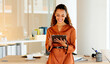 © Lumeez/peopleimages.com - Cheerful, smiling and happy latino business woman browsing on a digital tablet in a modern office. Portrait of confident entrepreneur feeling ambitious and motivated for success while planning online