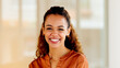 © Lumeez/peopleimages.com - Latino business woman smiling and laughing with joy in an office. Portrait of a confident and ambitious young entrepreneur feeling motivated, empowered and optimistic for success in a startup company