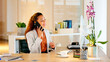 © Lumeez/peopleimages.com - Human resource manager talking on a call with employee explaining a strategy or contract. Female hr assistant scheduling an interview or meeting with a client while sitting at computer desk inside