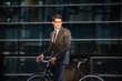 © oneinchpunch - Young handsome man with business suit driving bicicyle to go to office - Corporate businessman portrait biking in the city, concepts about business, green mobility and lifestyle