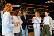 © Drobot Dean - Different age colleagues discussing their project during offline meeting