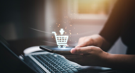 Wall Mural - Businessman using a laptop with online shopping concept, marketplace website with virtual interface of online Shopping cart part of the network, Online shopping business with selecting shopping cart.