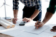 © kamiphotos - Architects and engineers are working together to edit the draft house plan that was designed after it was presented to the client and partially revised the design. Interior design and decoration ideas