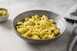 Pasta Orecchiette with sauce pesto on gray background. Close up. Italian typical cuisine.