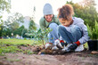 © N Felix/peopleimages.com - Volunteer, child and woman with plant for gardening in park with trees in nature environment. Happy family team helping and planting for growth, ecology and sustainability for community on Earth day