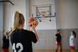 © Halfpoint - Young woman basketball player in gym, throwing ball in basket..
