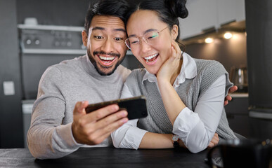 Wall Mural - Love, technology and couple with phone in home kitchen watching funny video online. Social media, wow and surprised asian man and woman with mobile streaming comic movie and laughing at night.