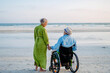 © Halfpoint - Senior man on wheelchair enjoying together time with his wife at sea.