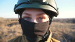 Sight of female ukrainian army soldier in helmet. Portrait of young woman in camouflage uniform confidently looking at camera. Military forces during war. Russian invasion of Ukraine. Close up