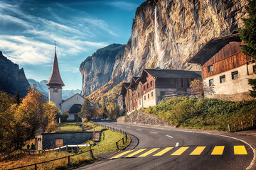 Fototapete - Wonderful autumn landscape. Lauterbrunnen village with awesome waterfall Staubbach and Swiss Alps in the background. Popular travel destination. Iconik location of Switzerland.