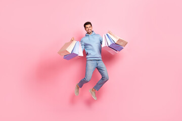 Poster - Full length photo of positive man rejoice nice shopping low prices trendy clothes new collection isolated on pink color background