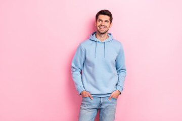 Poster - Photo of dreamy pretty man wear blue hoodie looking empty space smiling isolated pink color background