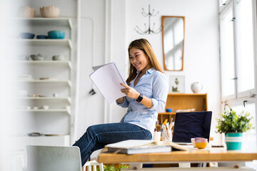 Canvas Print - Young female freelancer working in loft office
