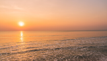 Wall Mural - sunset sky over sea in the morning with orange, red, pink sunrise