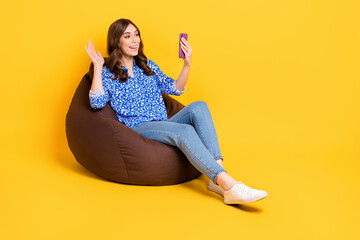 Poster - Full size portrait of positive girl sit comfy bag use telephone make selfie isolated on yellow color background